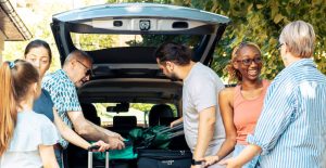 family-road-trip-loading-baggage-in-car-trunk-by-DC-Studio-AdobeStock-1024x530